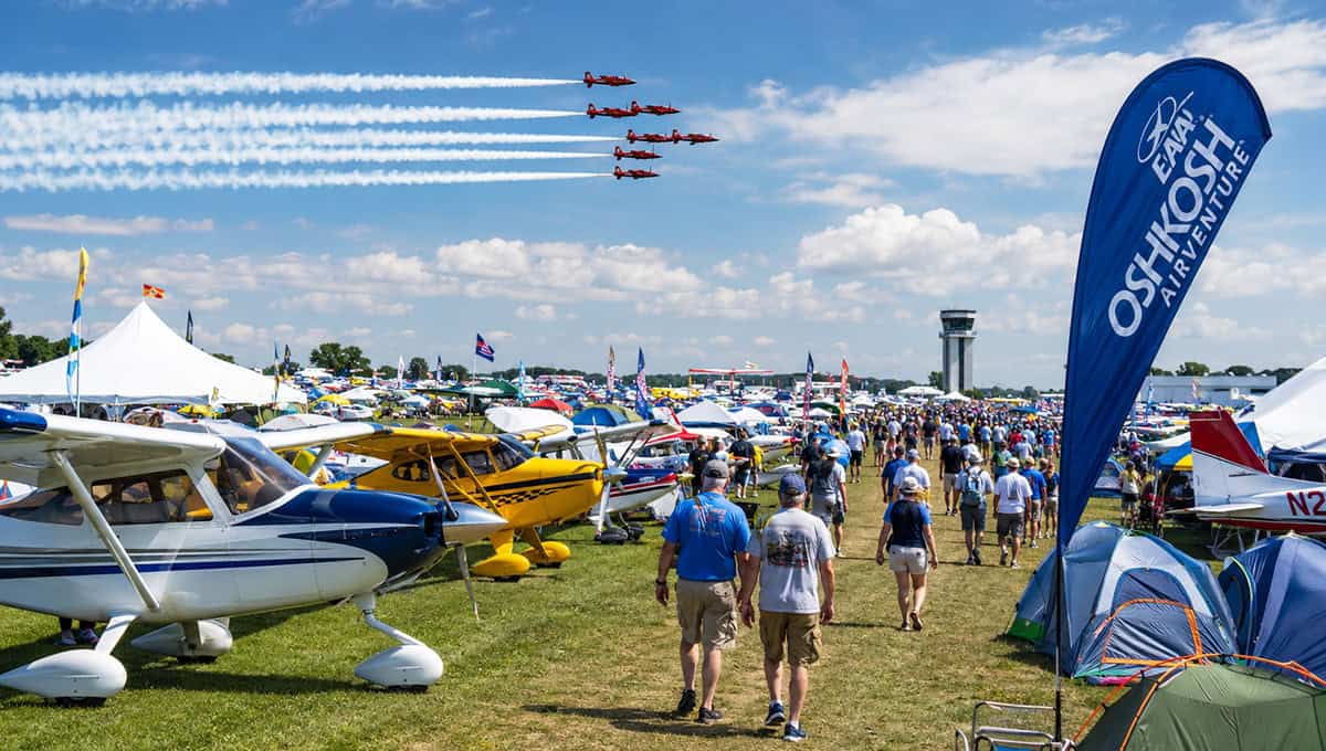 AirVenture Oshkosh 2026 with aircraft display and crowd.
